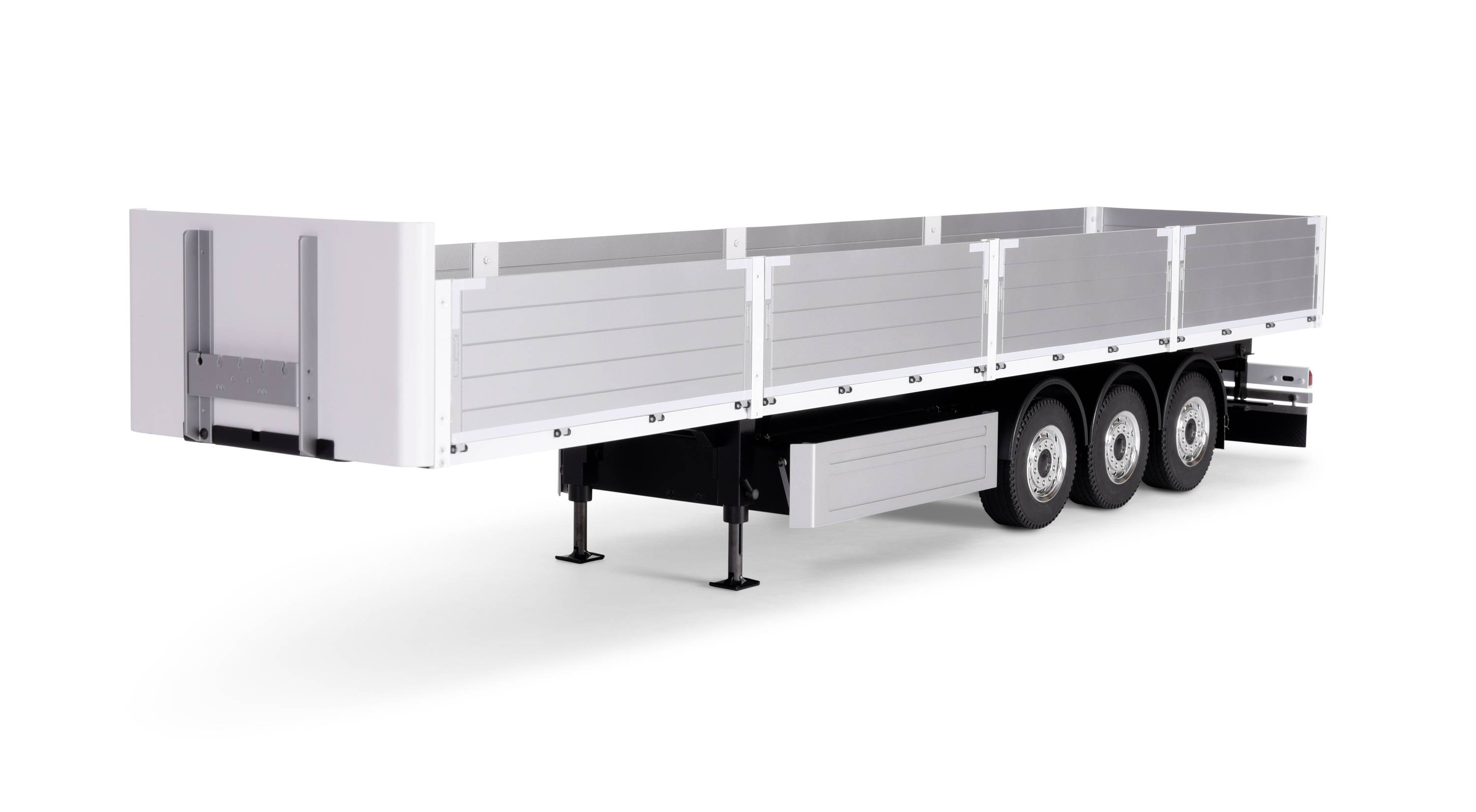 A three-axle trailer with flat side walls and support legs, suitable for transporting large, uncovered goods.