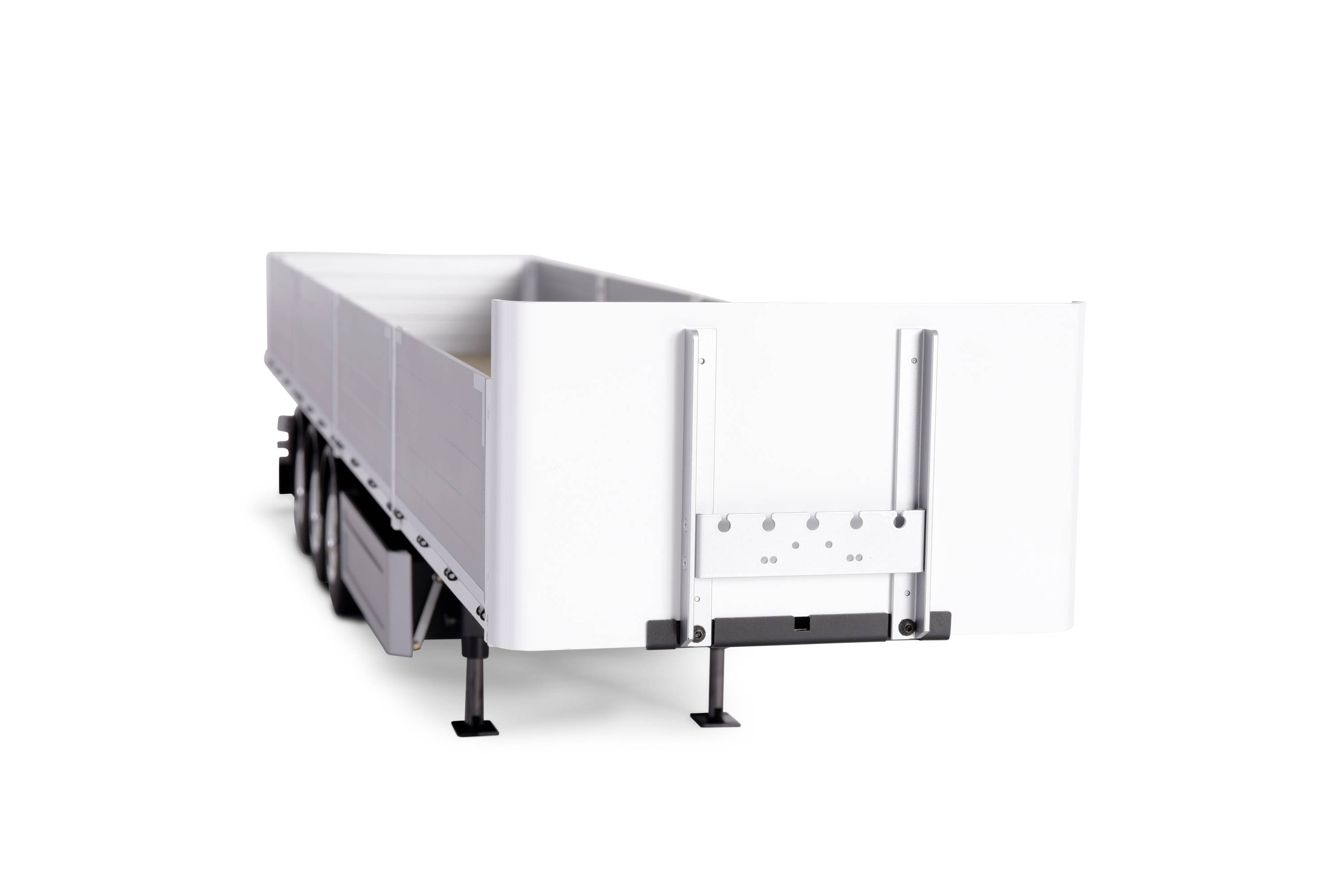 A white lorry trailer without markings is propped up on several supports. No surrounding environment is visible.