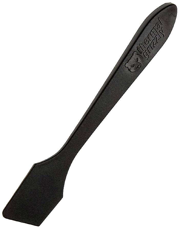 A black plastic spatula with a 'Thermal Grizzly' logo, used for applying thermal paste to computer chips.