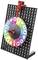 Colourful wheel of fortune on a black grid, displaying numbers and thumbs up/down symbols.