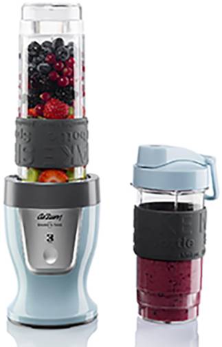 A blender with a transparent container, filled with berries, next to an additional cup with a prepared fruit smoothie.