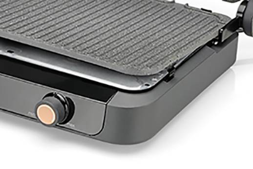 Black electric grill with ridged grilling surface and temperature control. Grill lid is partially open, suitable for indoor grilling.