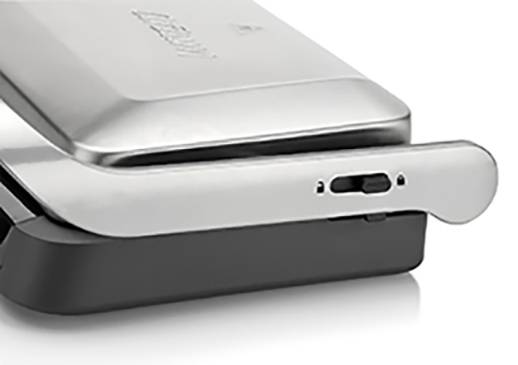 Silver and black kitchen appliance, likely a sandwich toaster or panini grill, with a lever and control knob.