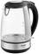 A transparent glass kettle with a black handle and water level indicator scale, with the brand name 'Arzum' visible.