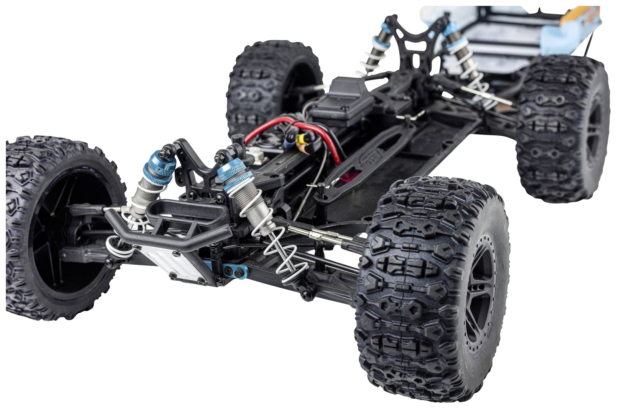 A remote-controlled car without bodywork reveals chassis details, large tyres, and suspension dampers.