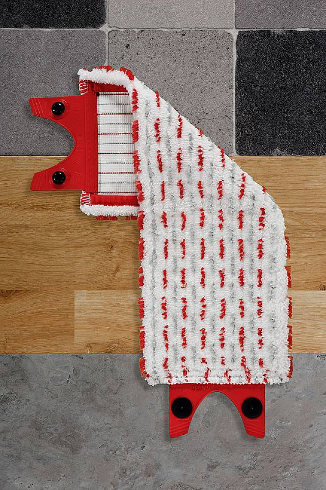 A red and white mop is lying on various floor coverings such as tiles, wood and stone, to demonstrate versatility.