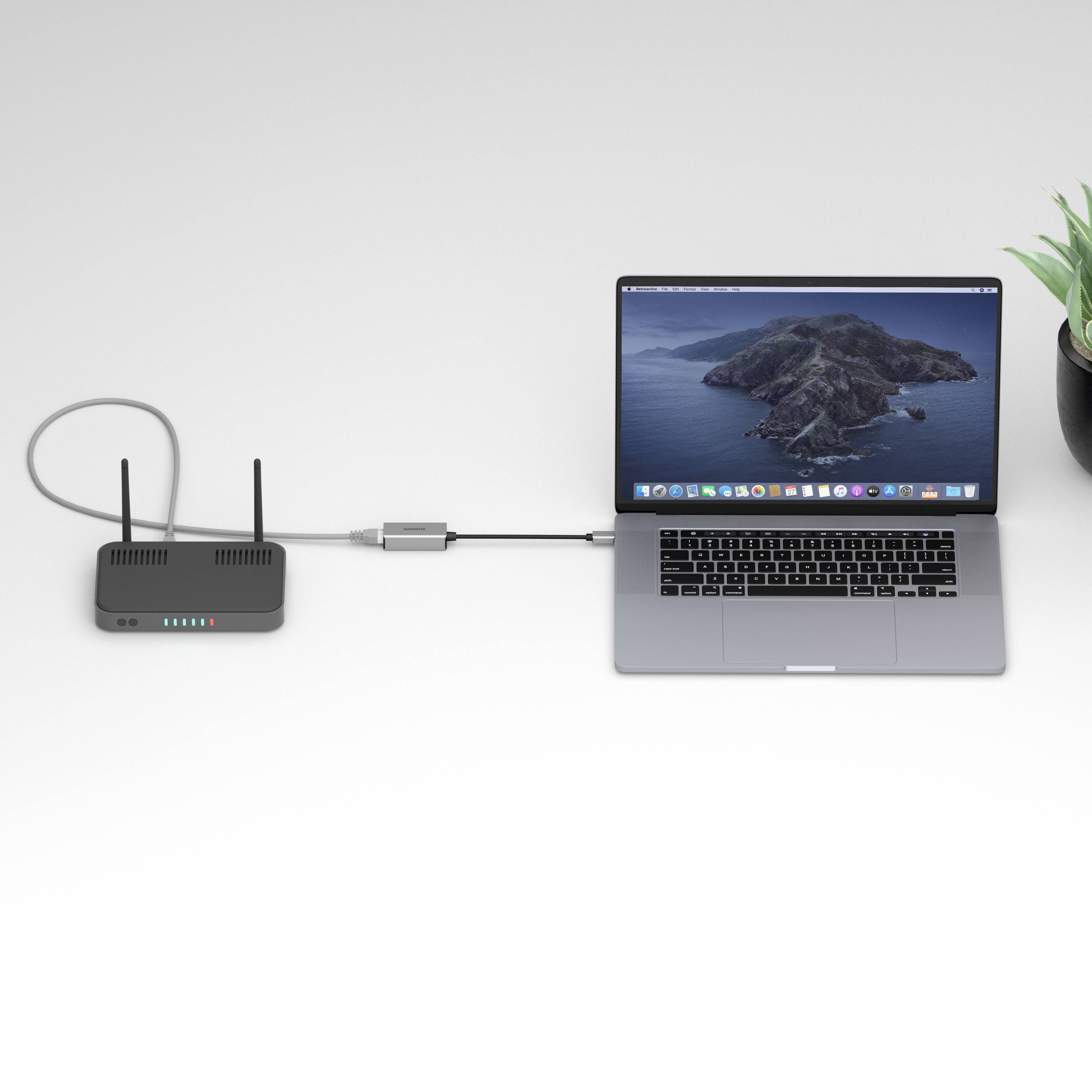 A laptop is connected to a Wi-Fi router via a cable. A small green leaf is situated next to the laptop.
