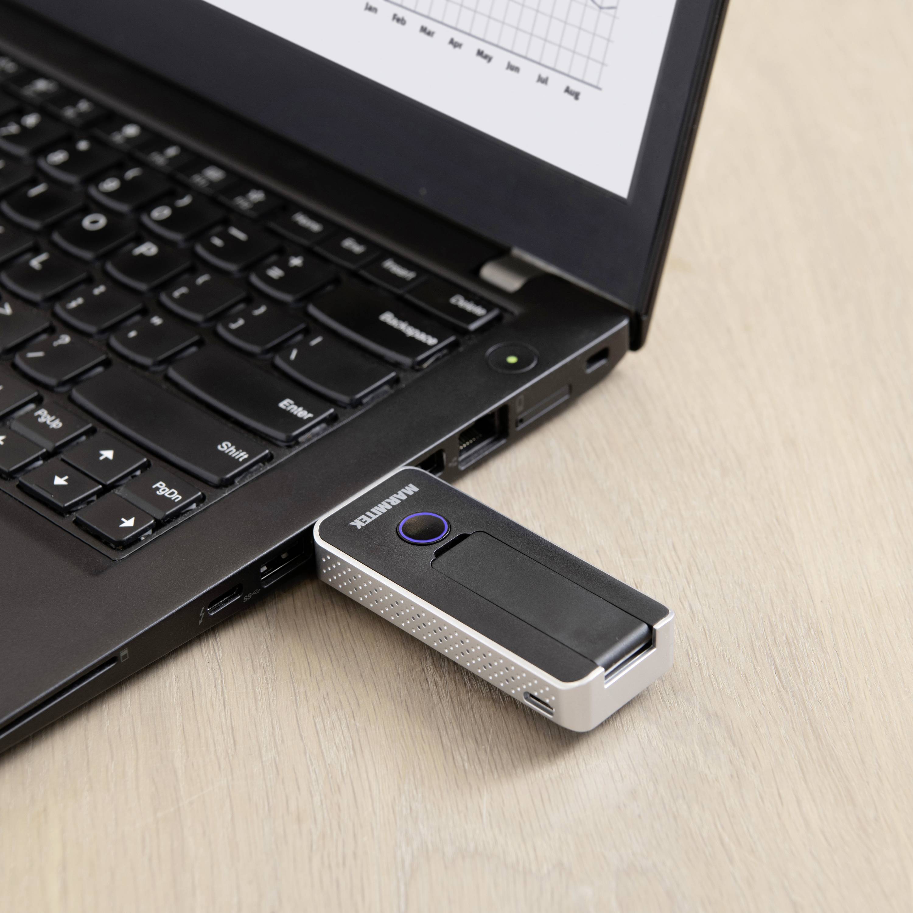 A USB stick is connected to a laptop. A diagram with data points is visible on the laptop screen.