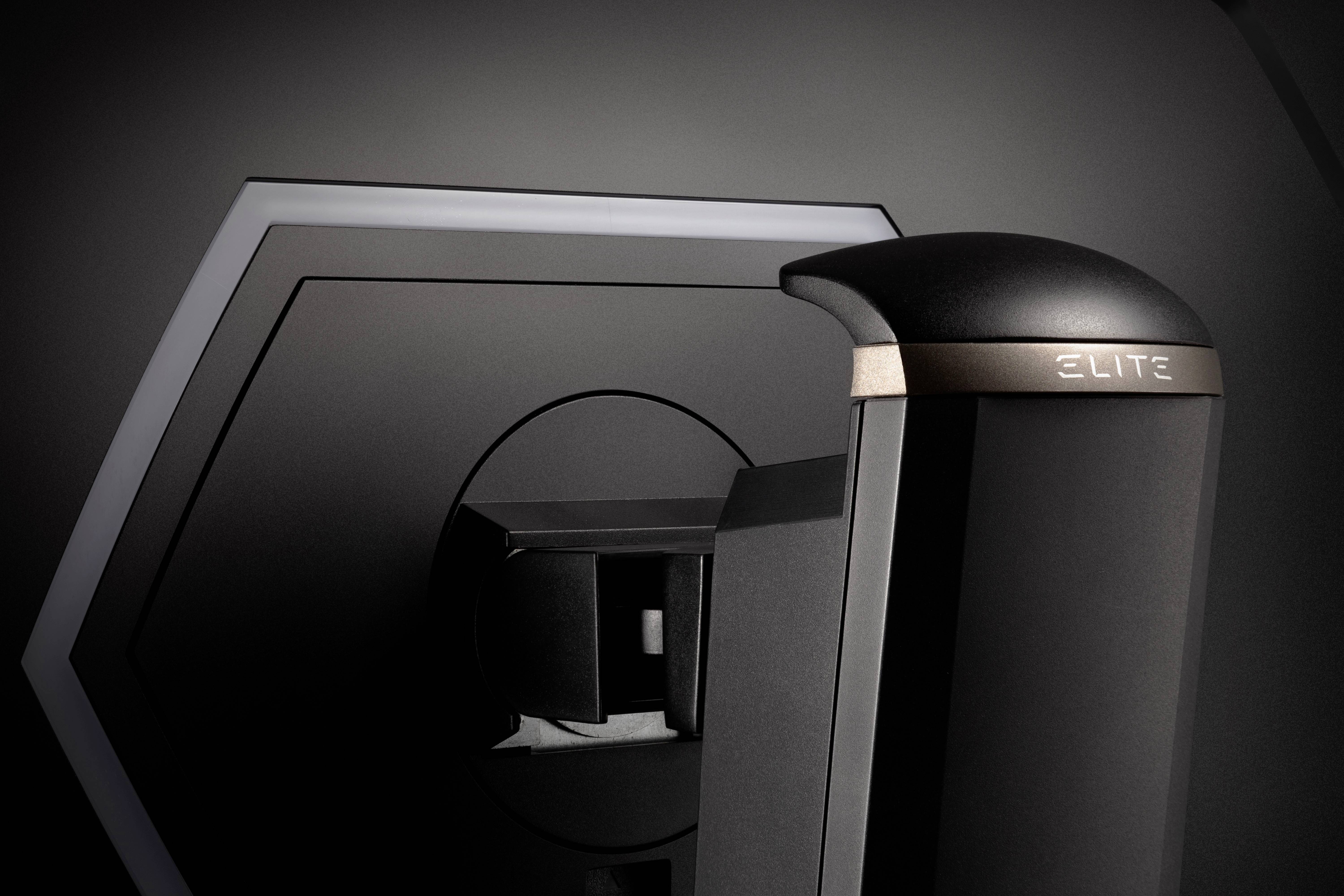 A dark, modern device with the inscription 'ELITE'. The design is futuristic and elegant, with geometric shapes in the background.