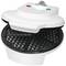A white waffle maker with an open lid, showing a heart-shaped waffle mould, ready for use.