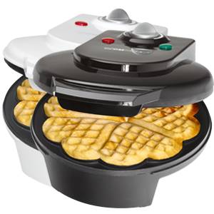 A black waffle maker with an open lid displays fresh, golden-brown heart-shaped waffles. Behind it, a white waffle maker.