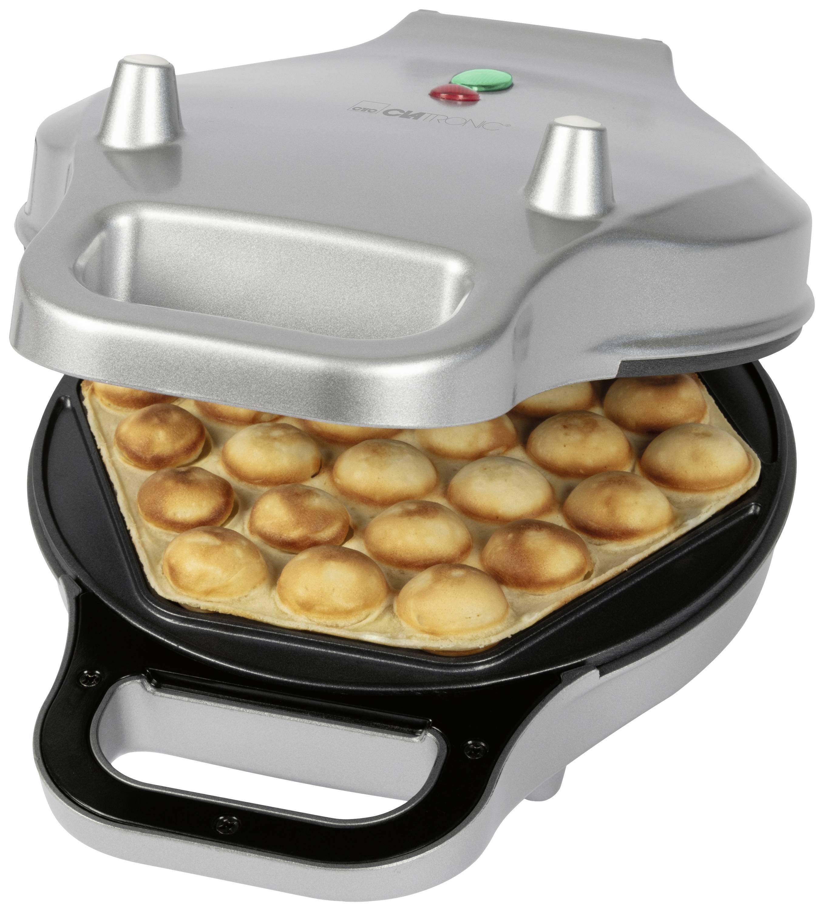 A silver waffle iron with a baked waffle inside, has round raised sections on both sides.
