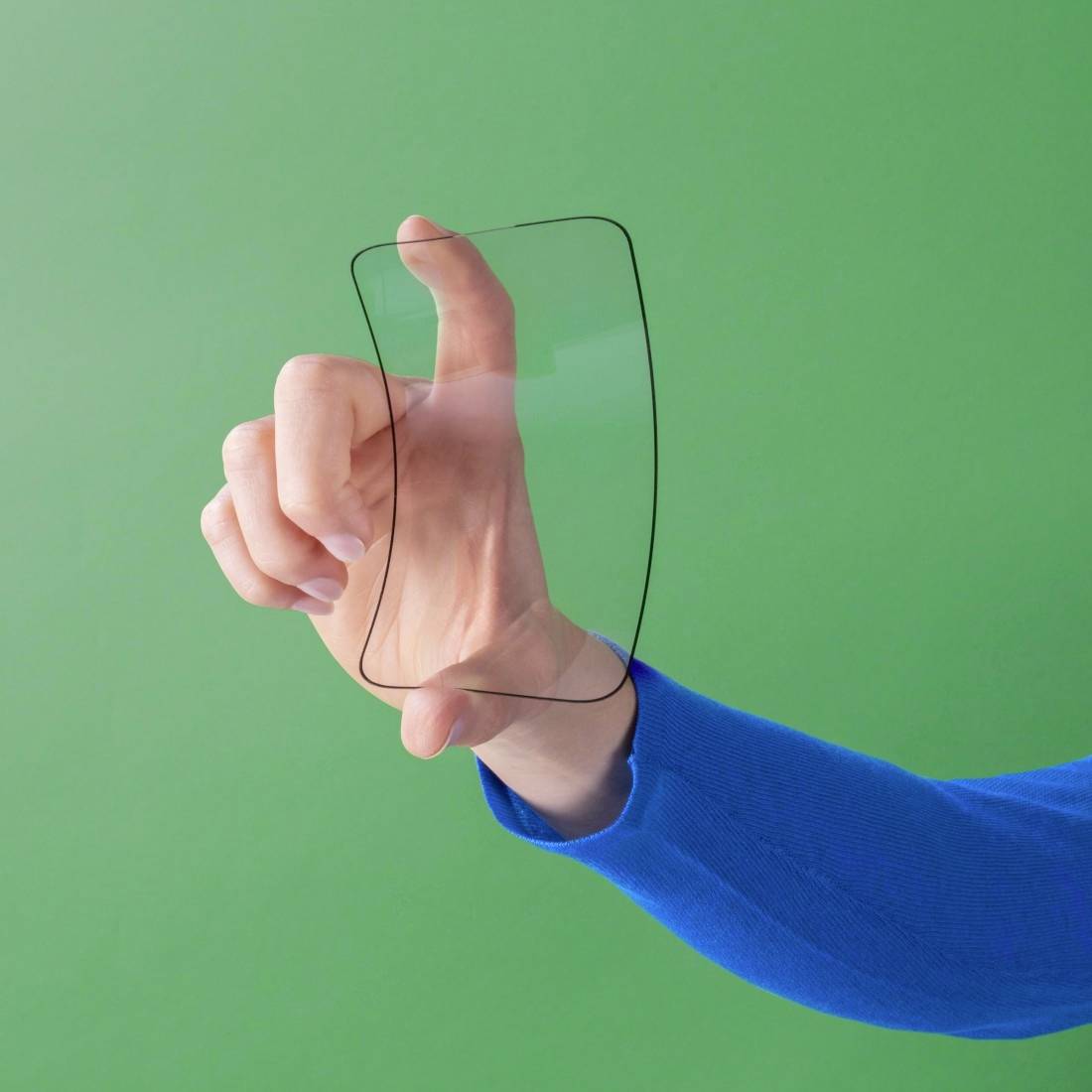 A hand holding a transparent, invisible rectangle against a green background symbolises modern technology.