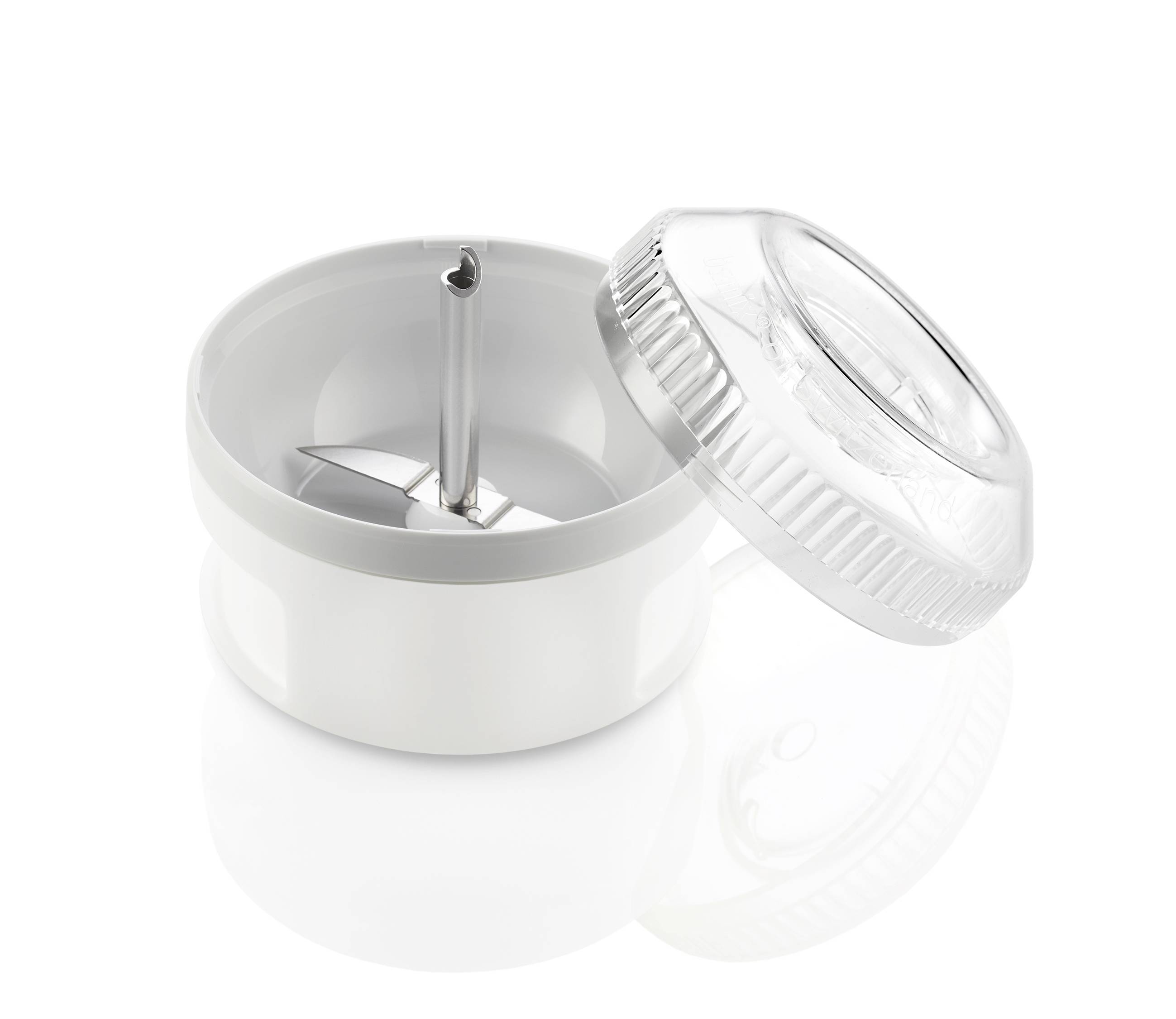 A pencil sharpener with a transparent lid, set against a white background. The sharpener reveals its sharp metal blade.