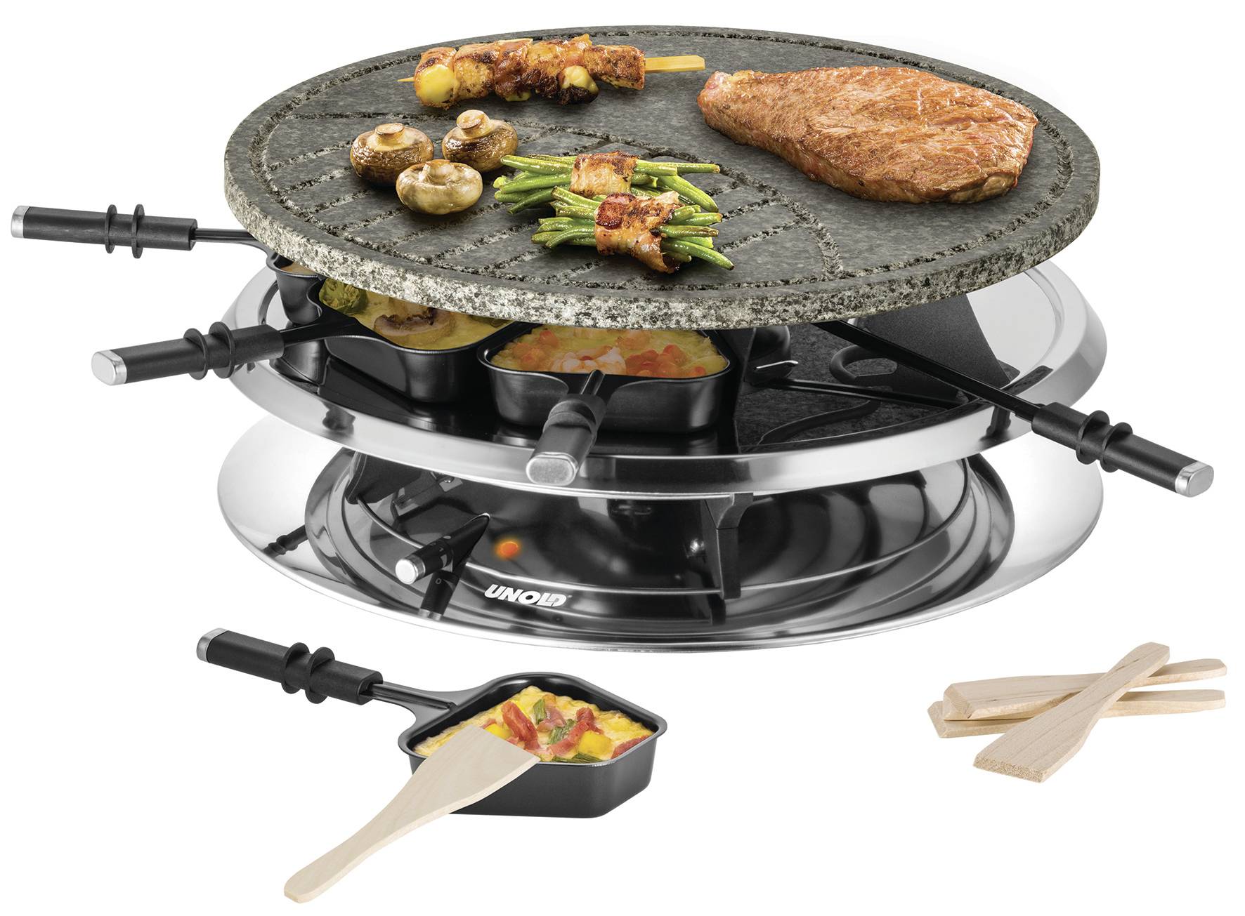 A raclette grill with a hot stone, on which meat, vegetables, and mushrooms are sizzling. Underneath, small pans with cheese and wooden spatulas.