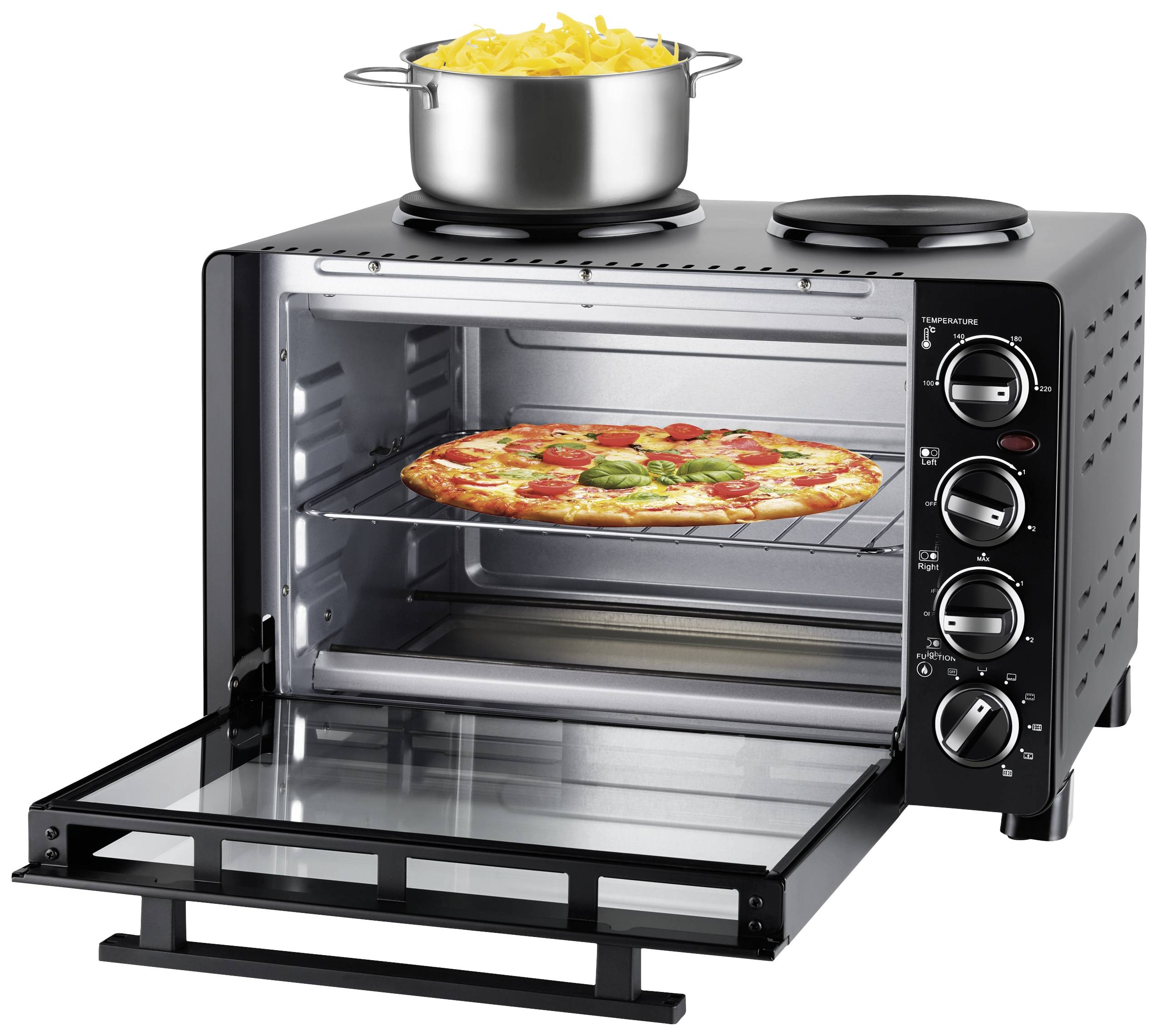 An open mini oven with a pizza on the rack. On the hob above, a pot of cooked pasta sits on the hotplate.