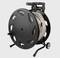 Black cable reel with long, coiled cable and carrying handle. Suitable for use in indoor and outdoor environments.