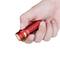A hand is holding a small, red torch with a textured grip, designed for compactness and easy handling.