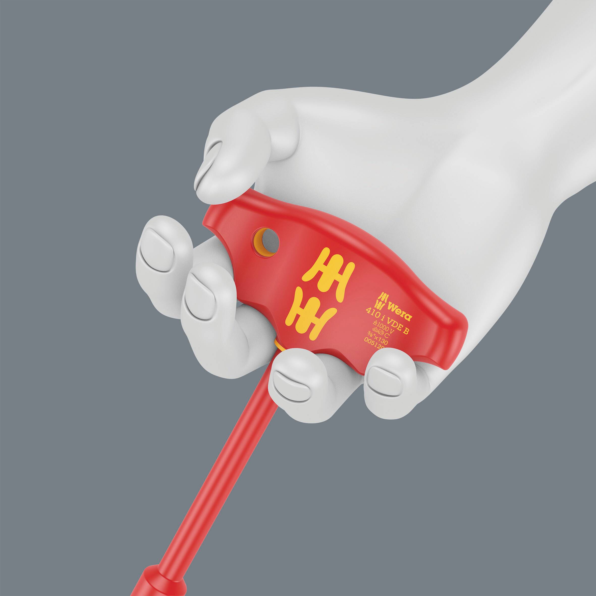 A white hand is holding a red Wera torque tool with a scale indicator to measure the tightening torque of a screw.