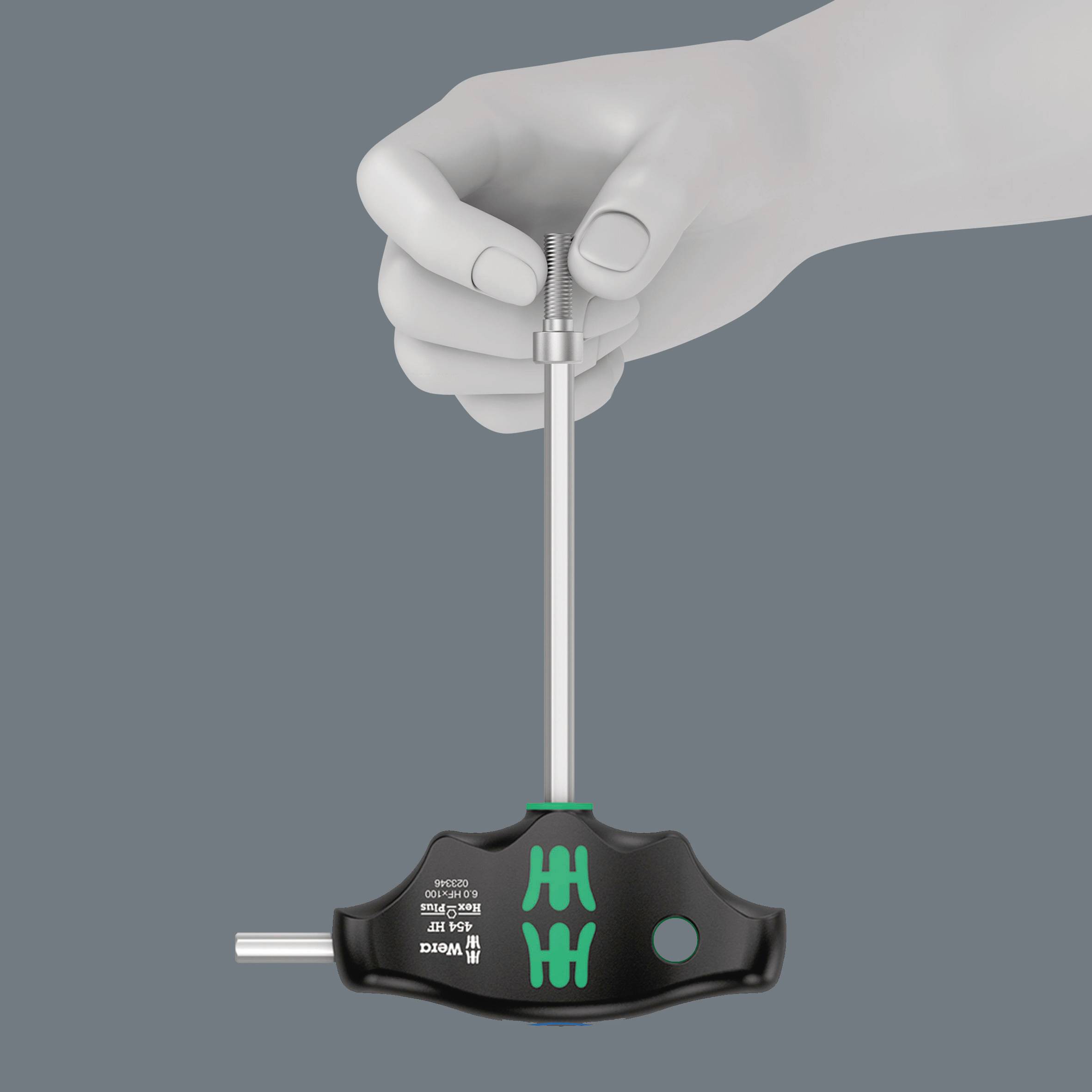 A hand is holding a black torque tool with a green accent, tightening a screw.