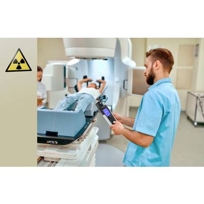 A medical technician is monitoring a patient lying in a radiotherapy device. Radiation safety symbols are visible.