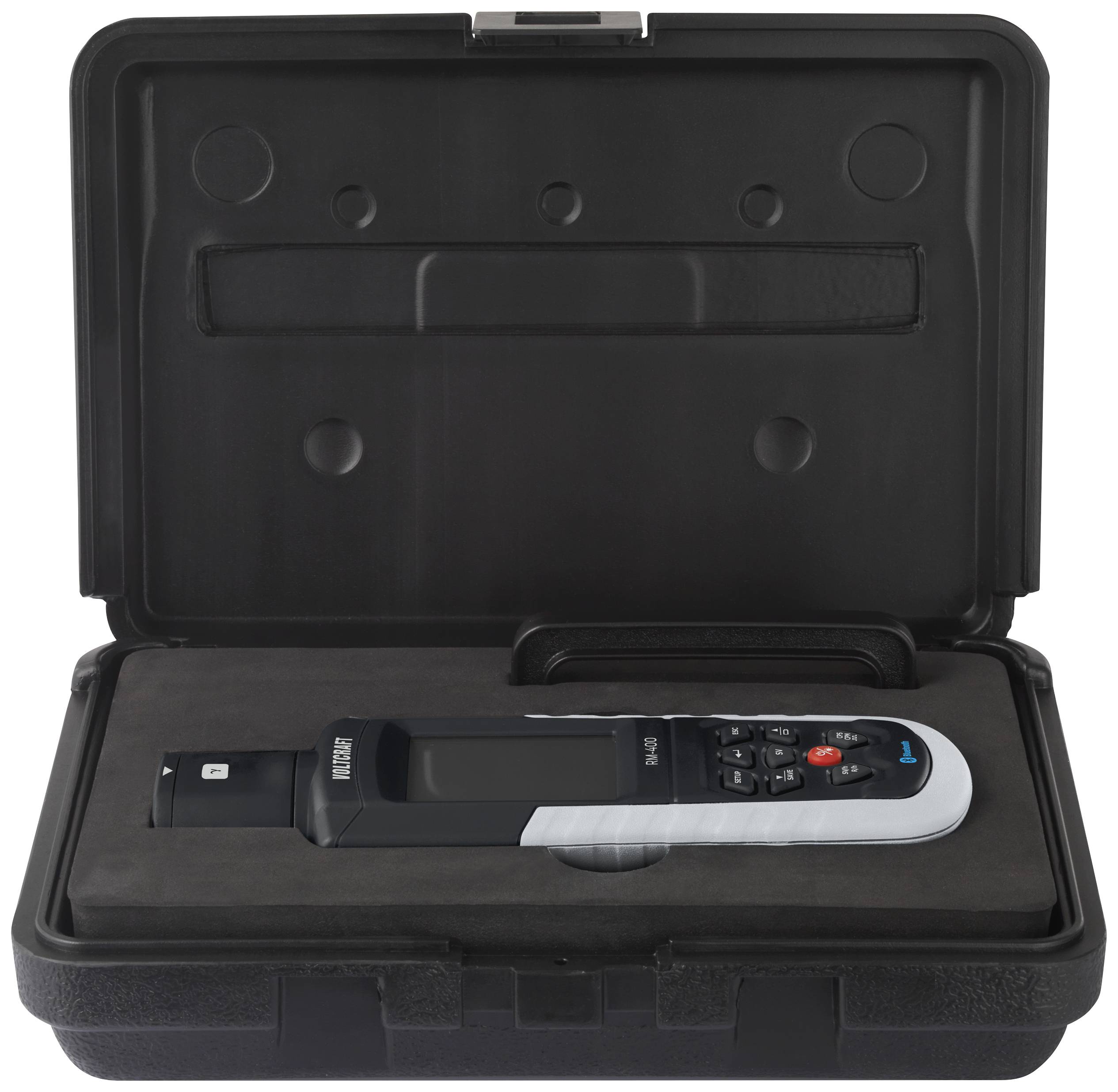 A black measuring instrument lies in an open black hard-shell case. The device has several buttons and is compactly manufactured.