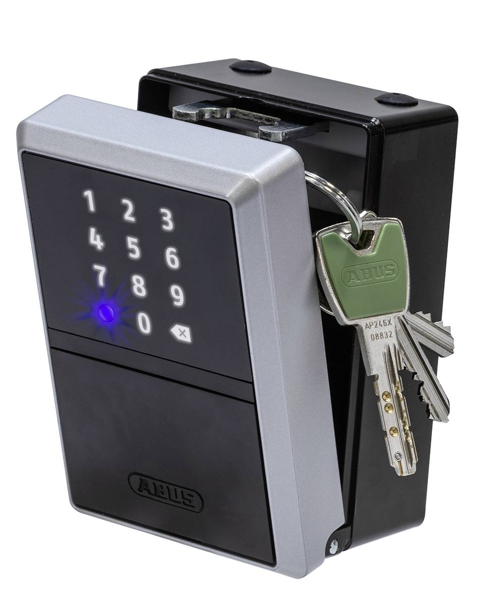 Key box with electronic numerical code and a bunch of keys in the lock. The numbers are arranged from 1 to 9.