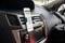 Smartphone mount in a car showing a navigation app with a street map on the screen.