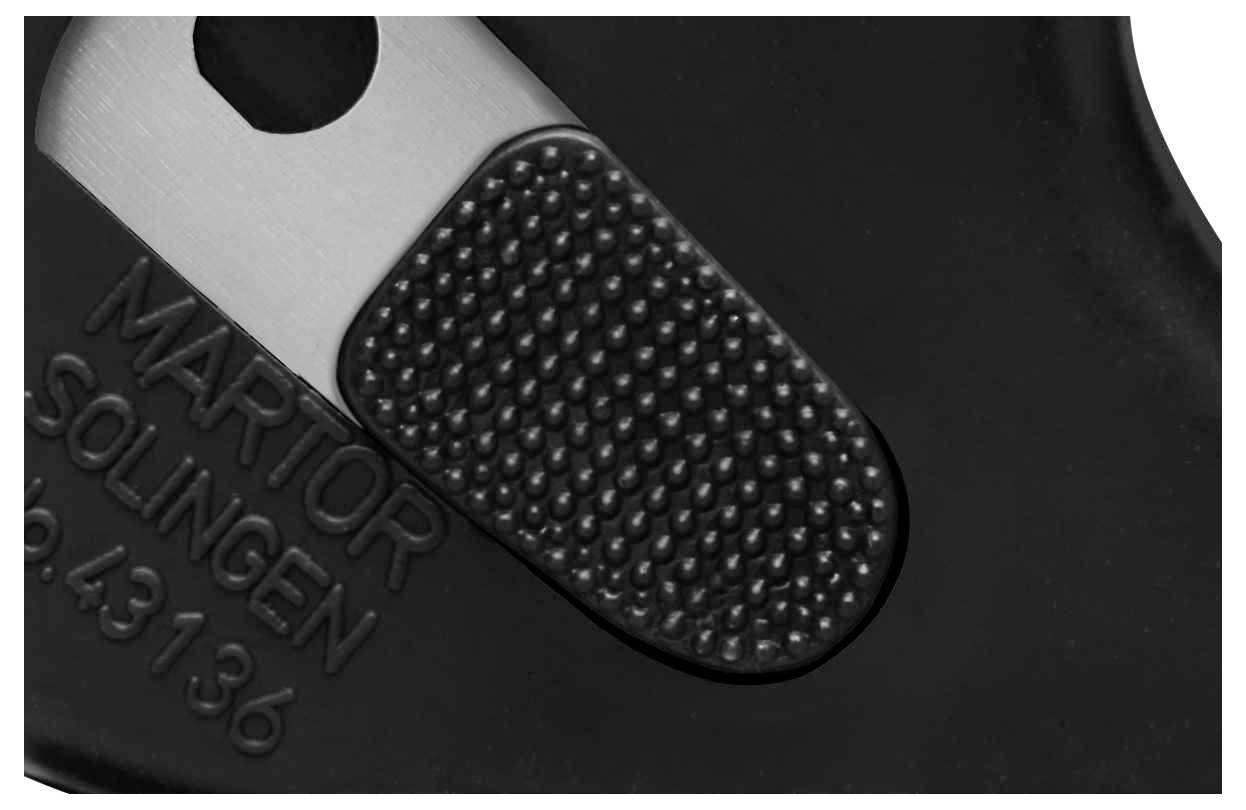 Close-up of a black tool with a ribbed, metallic surface and the engraved inscription 'Martor Solingen'.