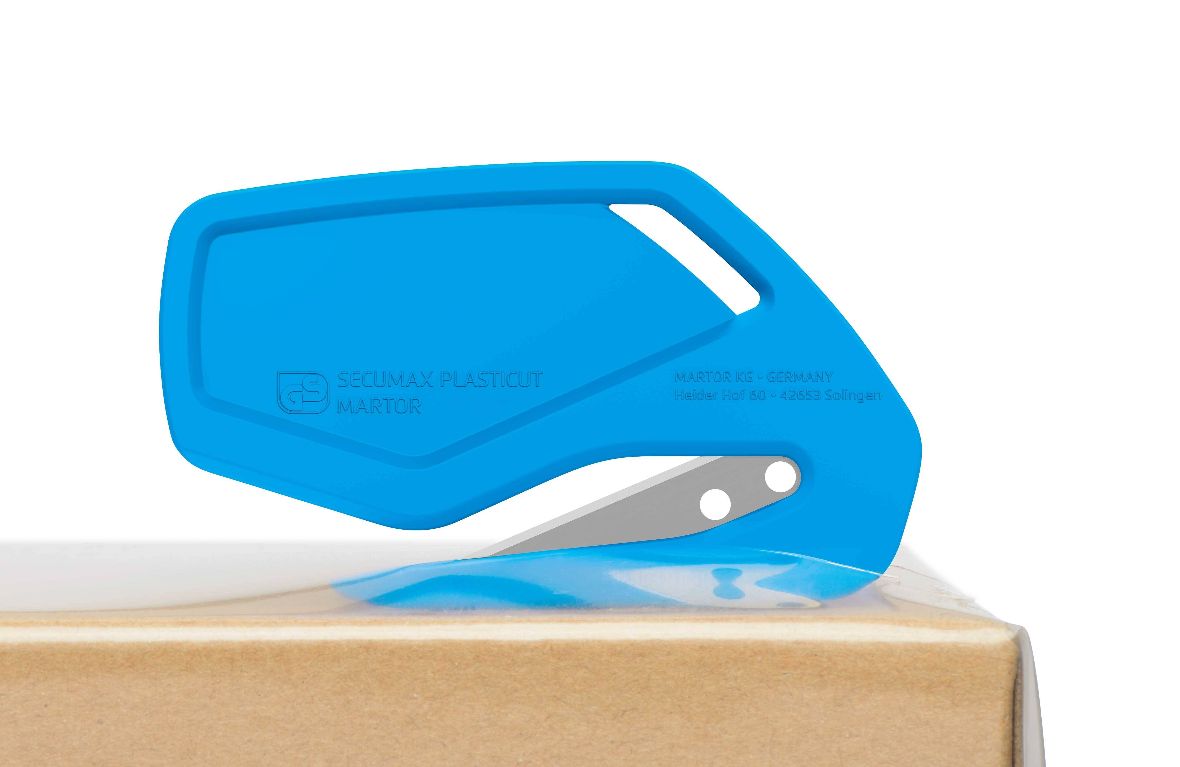 A blue safety cutter is cutting packaging material. The tool has a guarded blade to prevent injuries.