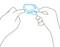 Two hands are holding a small, diamond-shaped device with a screen and buttons.
