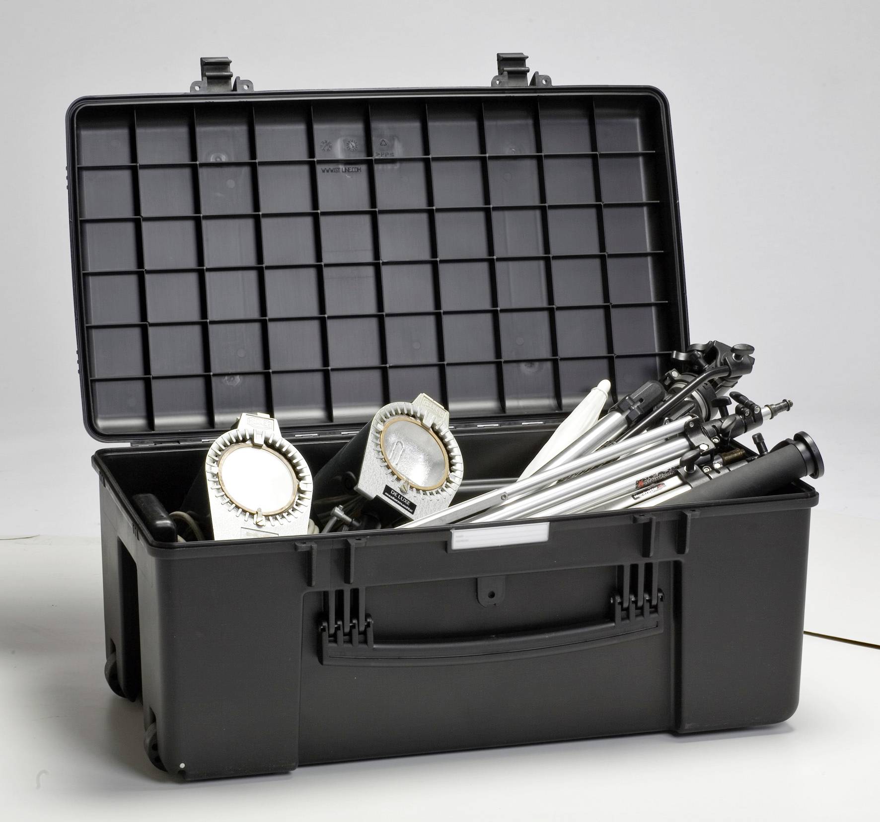 An open black suitcase reveals two studio lights and folded tripod stands. They appear to be intended for photography or videography.
