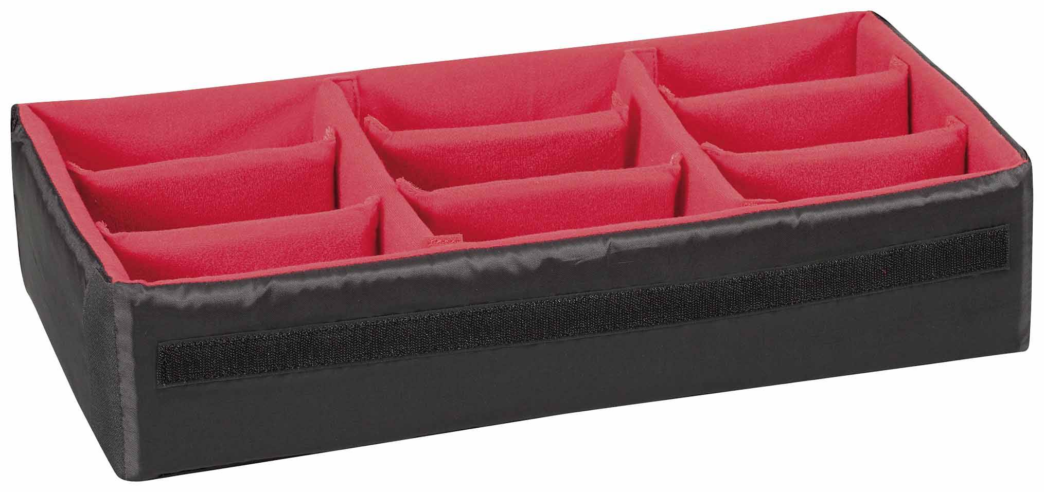 Black cable organiser with red dividing compartments for orderly storage of cables or accessories.