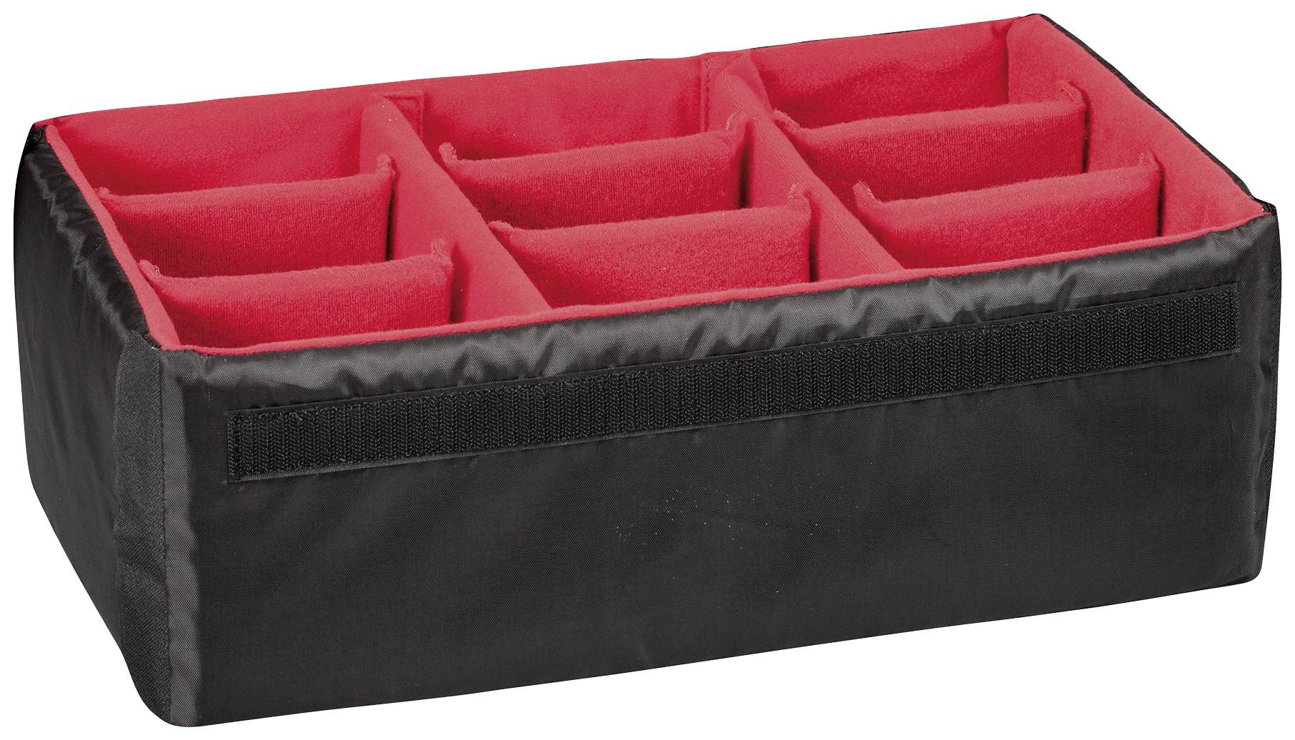 Black camera bag with red, padded compartments for organising camera equipment.