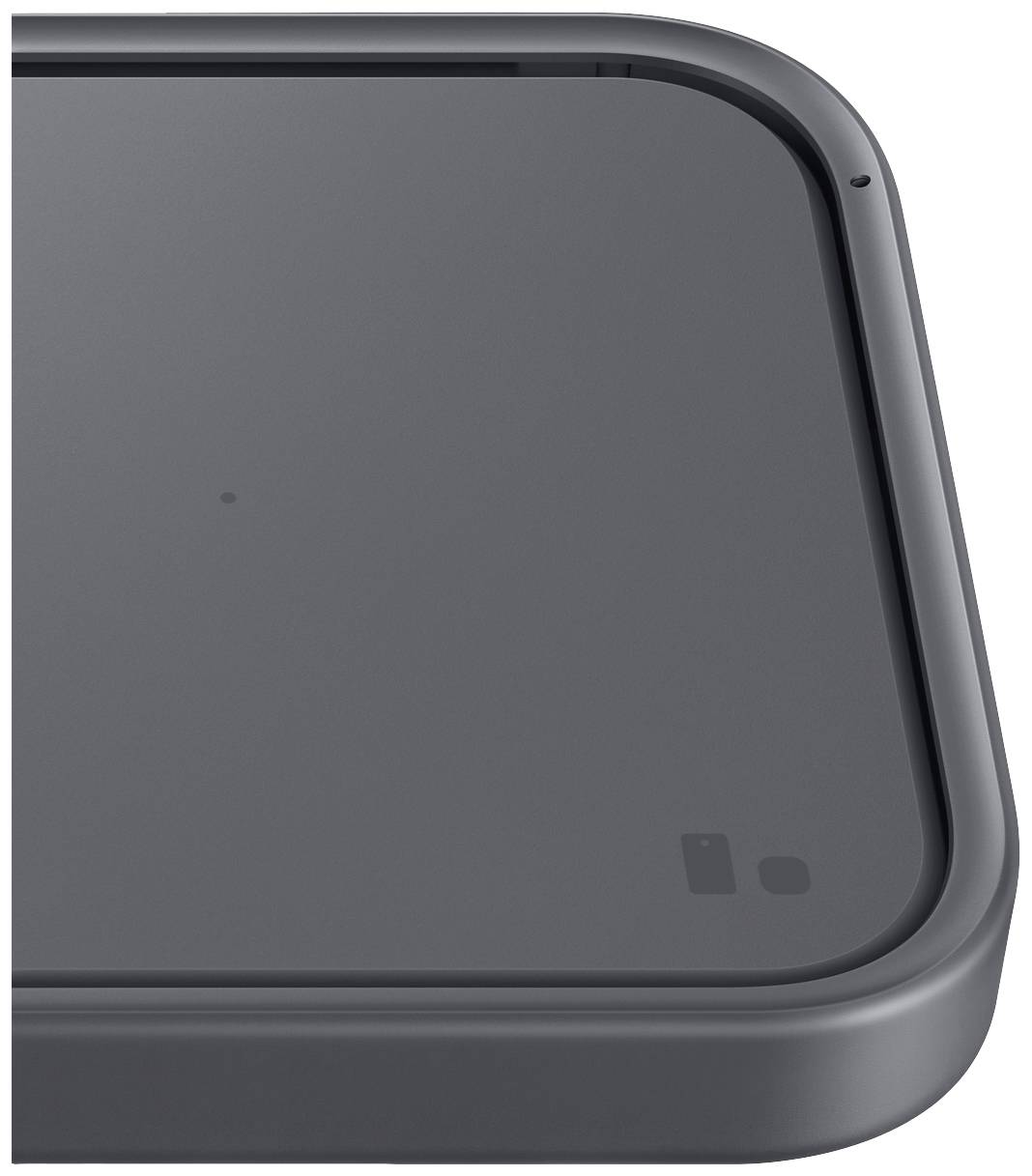 A grey, square device with rounded corners, possibly a charging surface or an electronic device.
