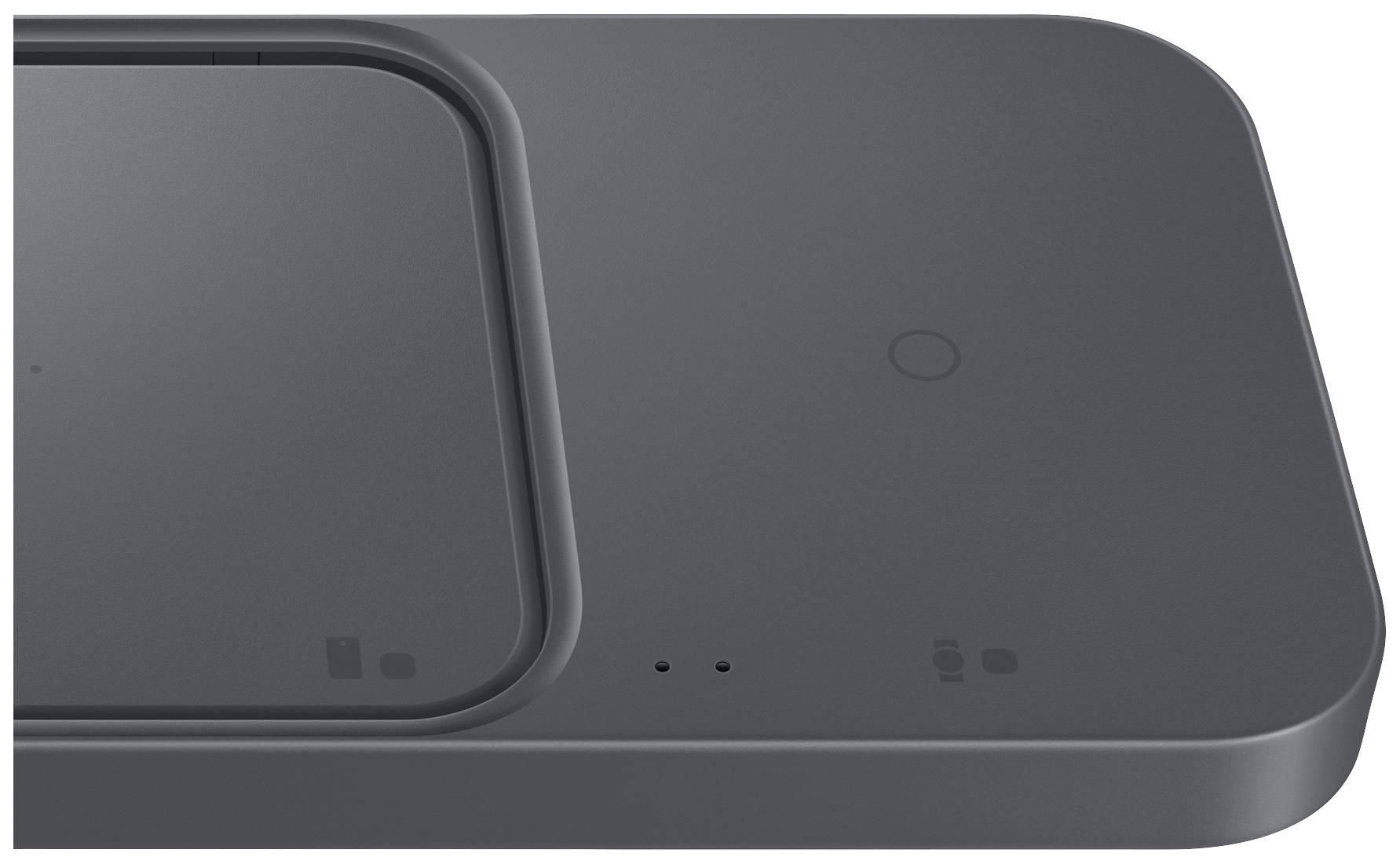 Wireless charger with two charging surfaces for simultaneous device charging. Minimalist, dark surface with minimal markings.