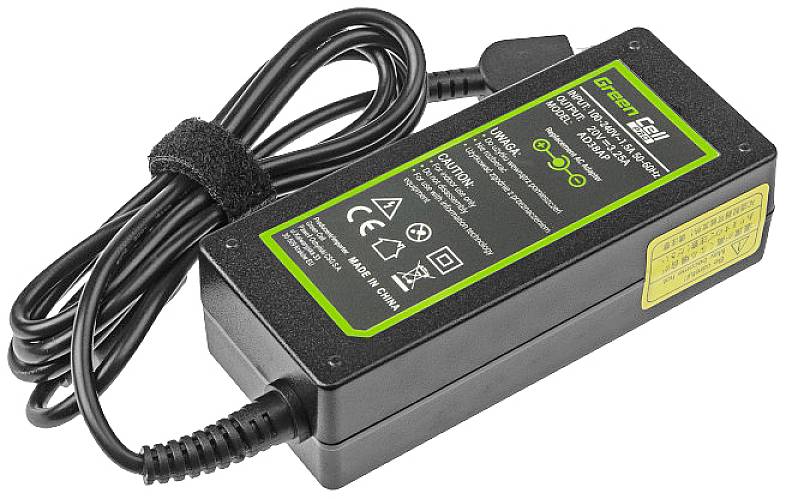 'Mains adapter with cable, black casing, green labelling. Contains symbols for safety, energy efficiency, and certifications.'