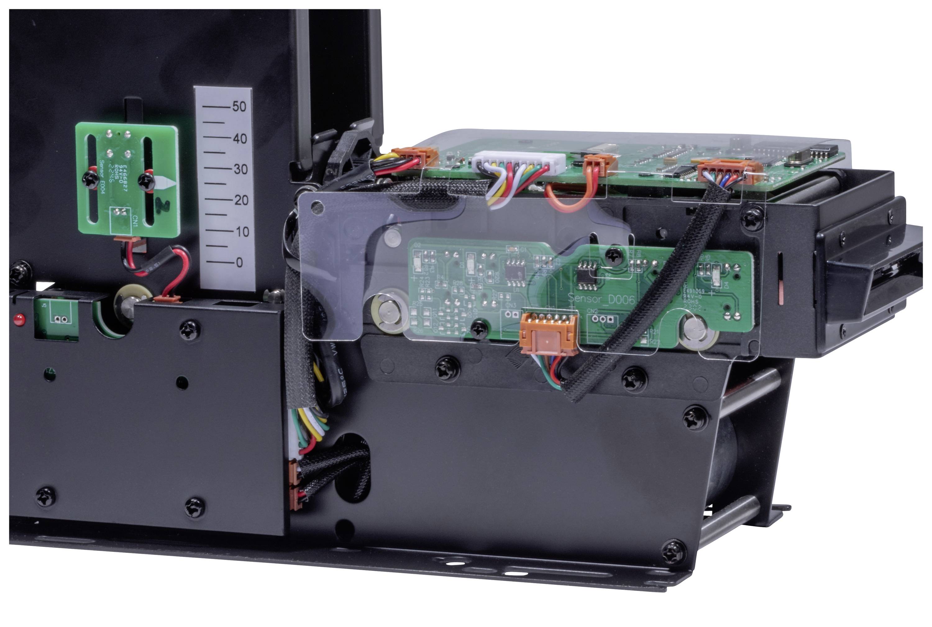 An electronic device with circuit boards, cables, and a green measuring instrument on the left side, potentially a measurement or control device.