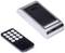 Black remote control with number keys next to a flat, silver card reader.