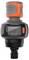 A digital water flow meter with an LCD screen displaying measurement data. It is compact, with an orange and black design from Gardena.