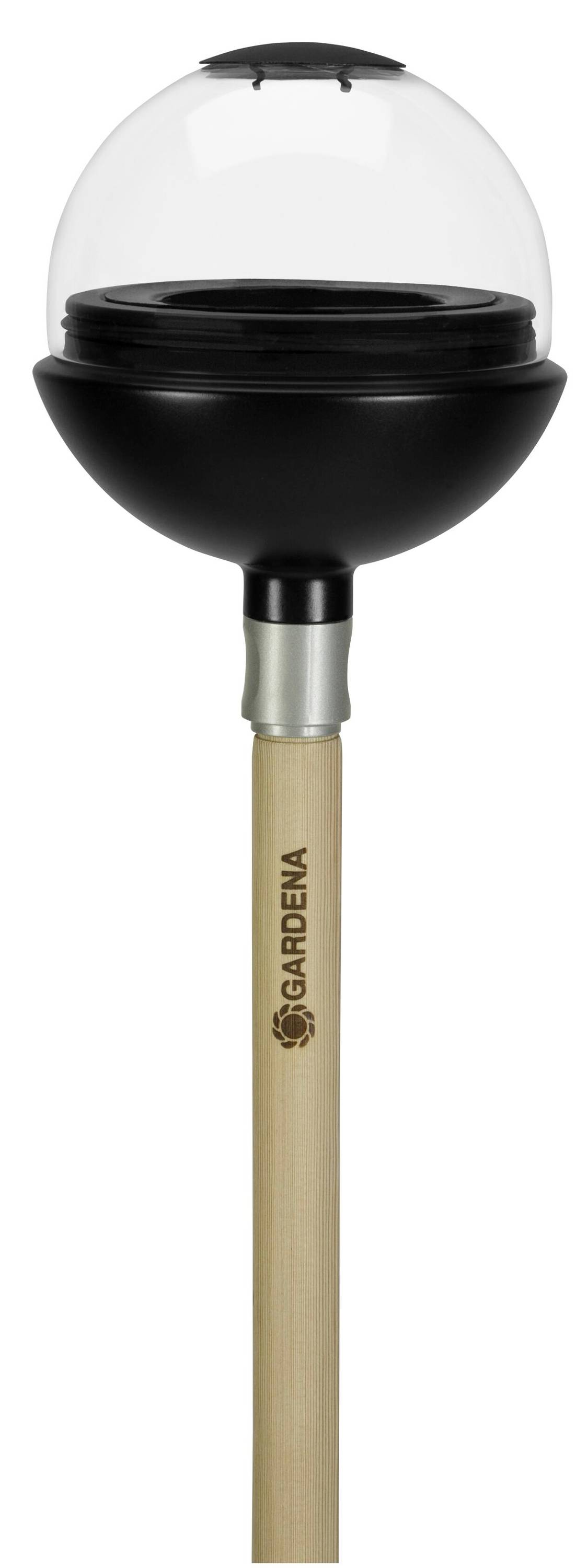 A watering system plug with a transparent lid on a wooden stick. The brand name is printed on the stick.