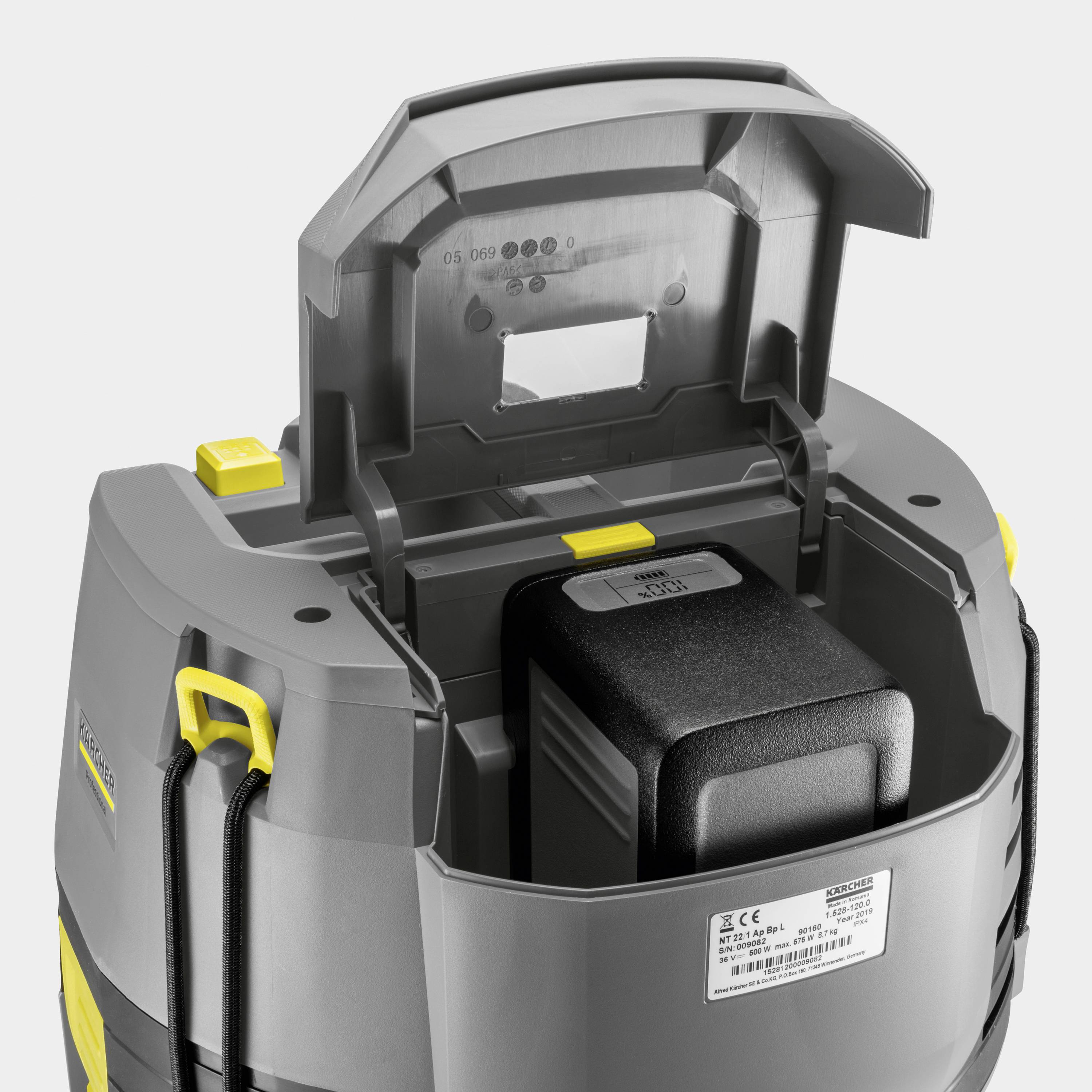 An opened, grey and yellow device with a visible battery inside. Possibly an electronic device for cleaning or maintenance.