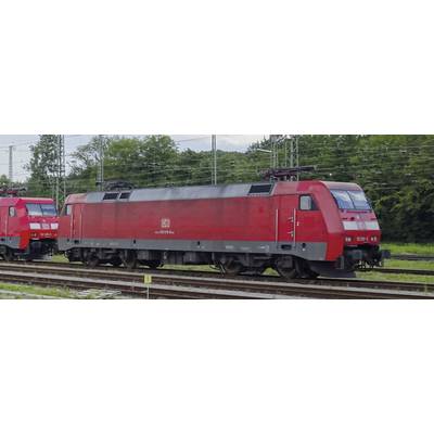 Two red locomotives are standing on parallel tracks in a green environment. Electrical overhead lines are visible in the background.