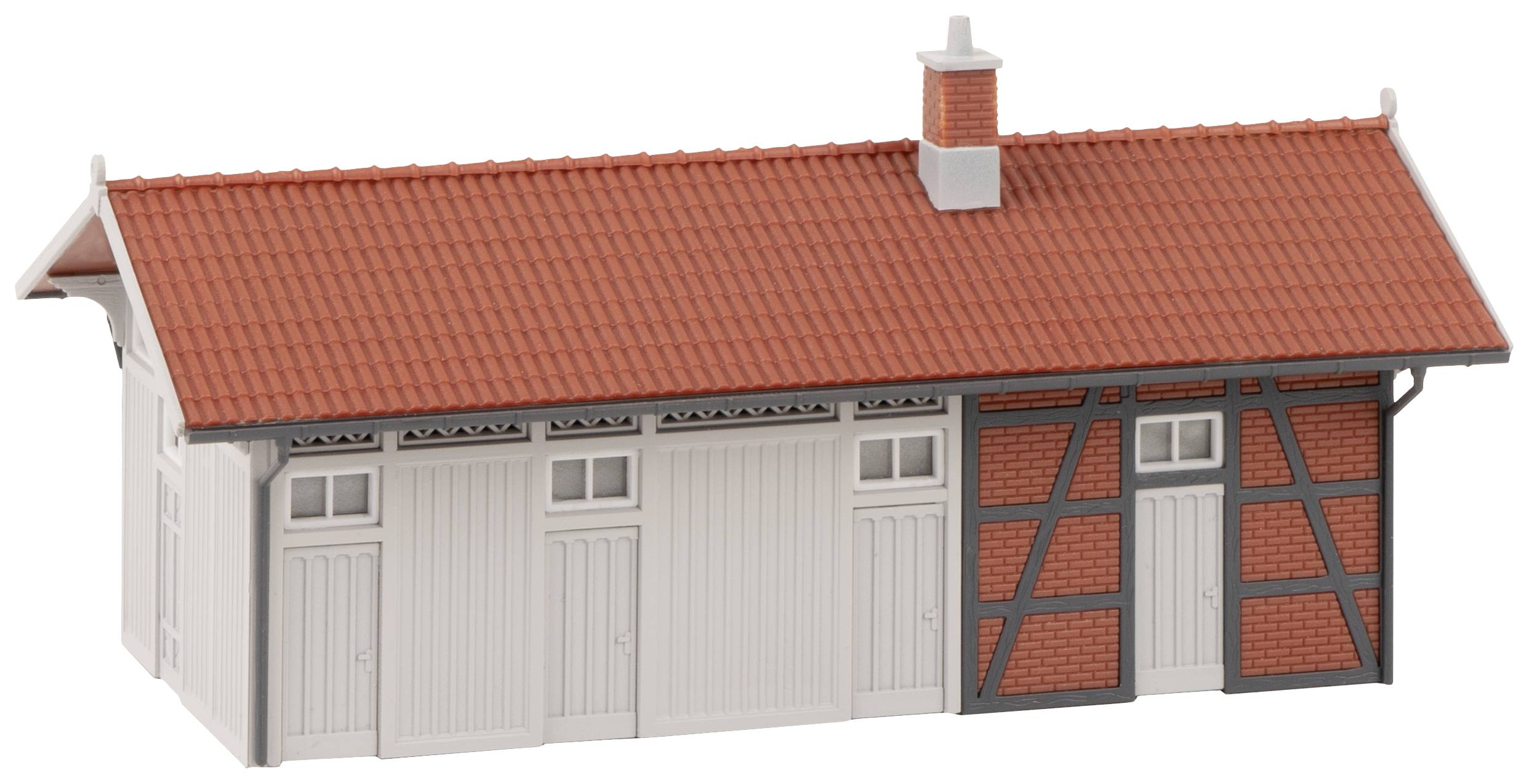 A simple model building with a red tiled roof, white walls and half-timbered details.