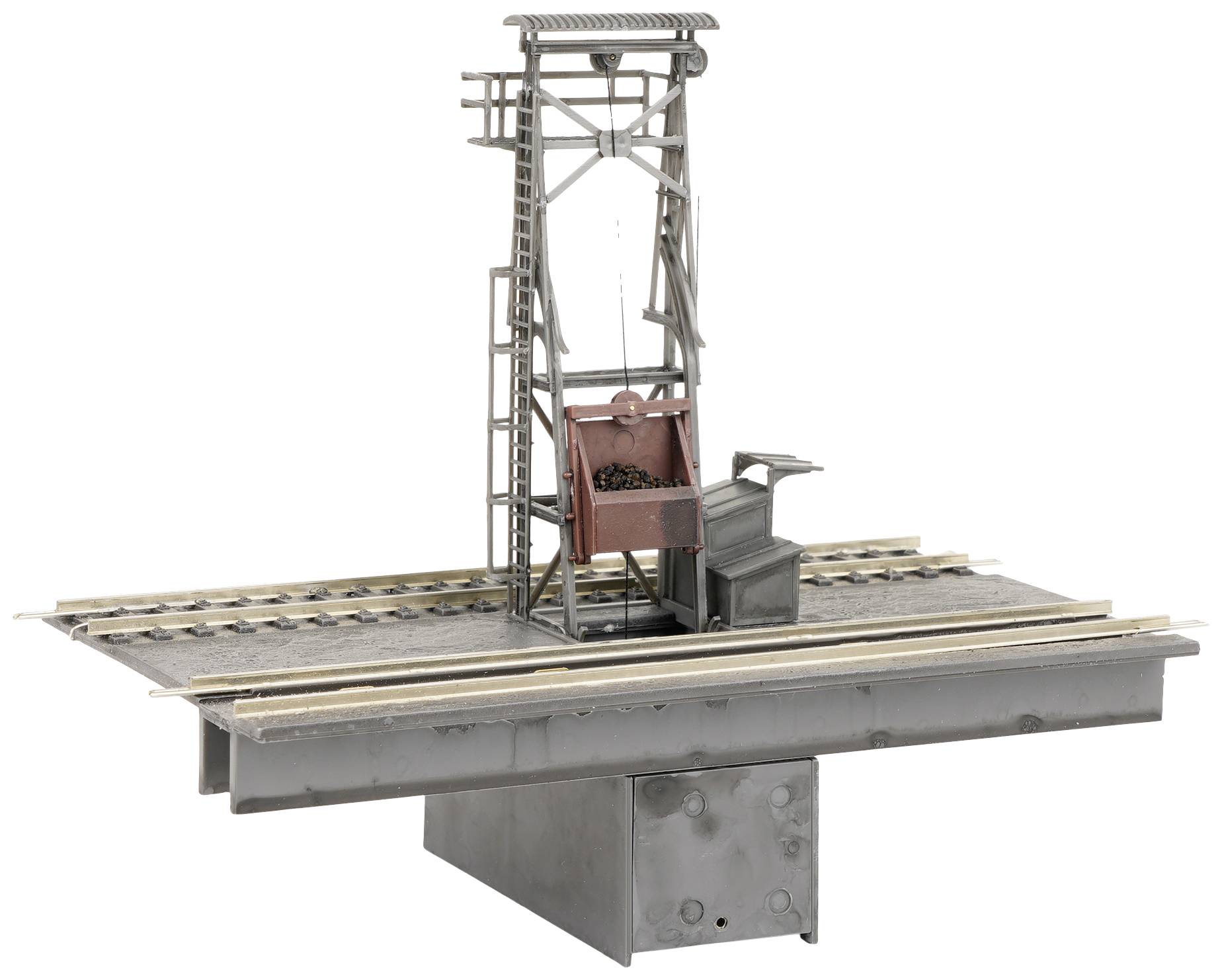 A model of a metal railway loading ramp with rails and a conveyor belt demonstrates industrial architecture at a miniature scale.
