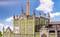 A model of an old factory with a green façade and brick tower against a blue sky. Poster displays 'Brewery'.