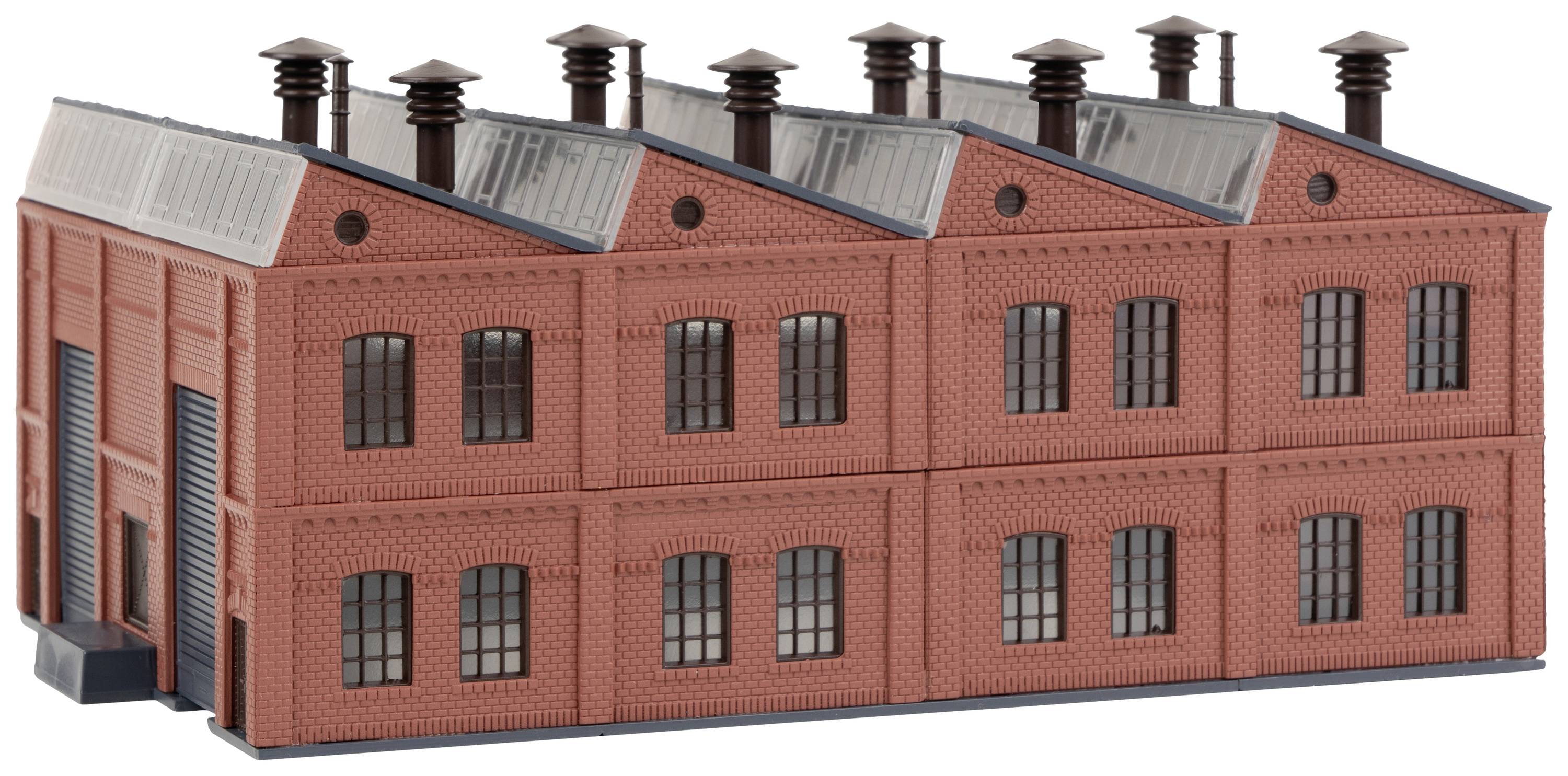 A red brick building with large windows and chimneys on the roof, designed in the style of an industrial building.