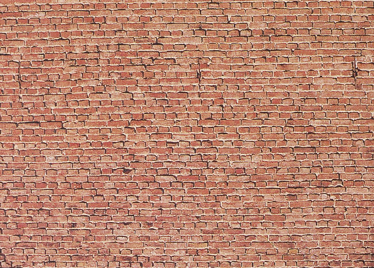 Close-up of a brick wall, showing irregular mortar joints, textured, rust-brown brickwork.
