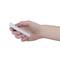 A hand is holding a white remote control pointing downwards.