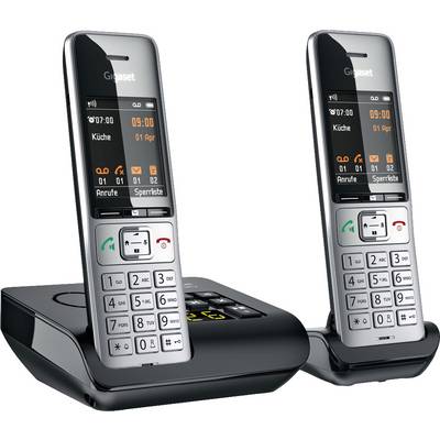 Two black cordless telephones with display and keypad on charging stands. Showing date, time and 'Kitchen'.